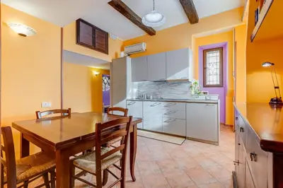 a kitchen with a wooden table and a dining room at Casa Garbha in Rome
