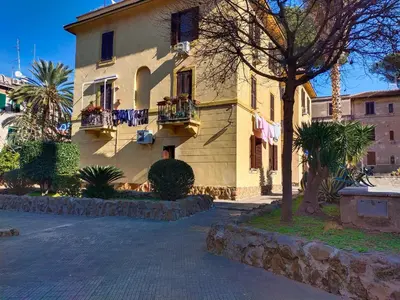 a yellow building with two balconies on a street at Casa Garbha in Rome