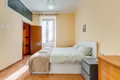 a bedroom with a bed and a dresser in it at Casa Garbha in Rome