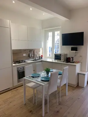 a kitchen with a table and chairs in a kitchen at Annalisa Home in Rome