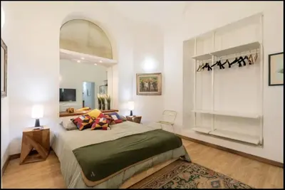 a bedroom with a large bed and a large window at Barberini Exclusive Apartment in Rome