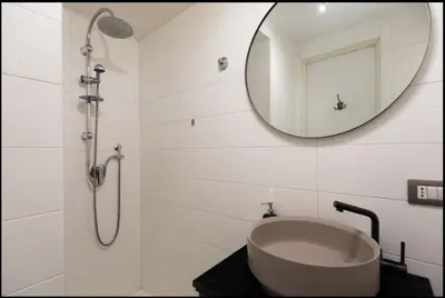 a bathroom with a sink and a mirror at Barberini Exclusive Apartment in Rome