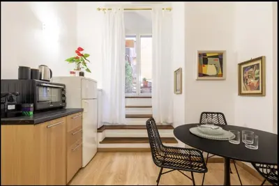 a kitchen with a table and chairs and a microwave at Barberini Exclusive Apartment in Rome