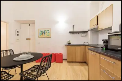 a kitchen and dining room with a table and chairs at Barberini Exclusive Apartment in Rome