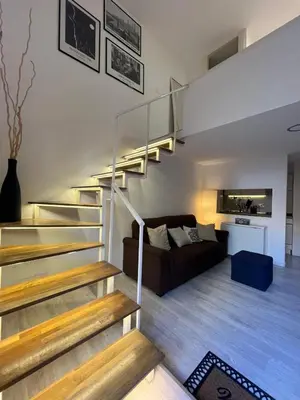 a living room with a staircase and a couch at LaDolcevita - Casa Milvia in Rome