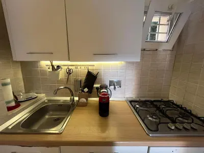 a kitchen counter with a sink and a stove at LaDolcevita - Casa Milvia in Rome