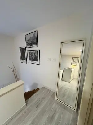 a mirror in a room with a white wall at LaDolcevita - Casa Milvia in Rome