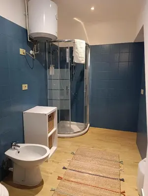 a bathroom with a shower and a toilet and a sink at Suite San Giovanni in Rome