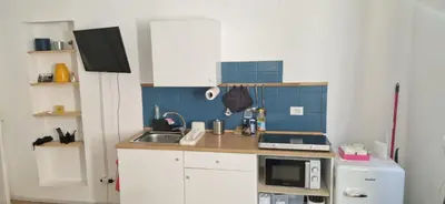 a small kitchen with a sink and a microwave at Suite San Giovanni in Rome