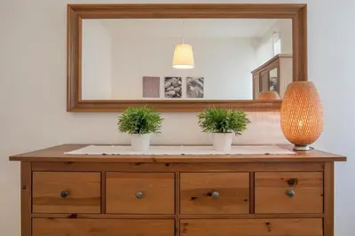 a dresser with two potted plants on it with a mirror at Romeathome146 - Monti in Rome