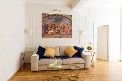a bedroom with a large bed with a chandelier at Golden Palace Luxury Guest House in Rome