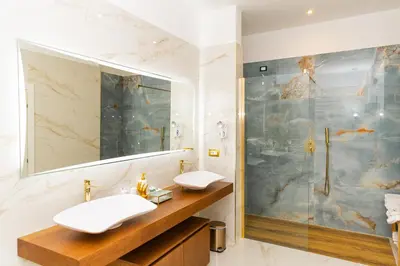 a dining room with a table and chairs and a mirror at Golden Palace Luxury Guest House in Rome