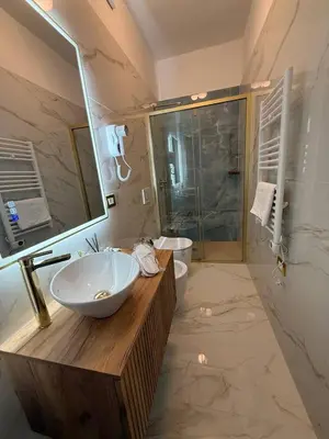 a door leading into a living room with a couch at Golden Palace Luxury Guest House in Rome