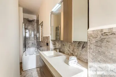a bathroom with a sink and a tub and a mirror at Emily in Rome in Rome