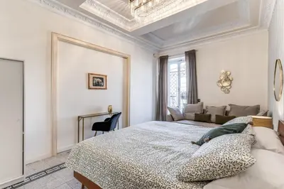 a white bedroom with a bed and a couch at Emily in Rome in Rome