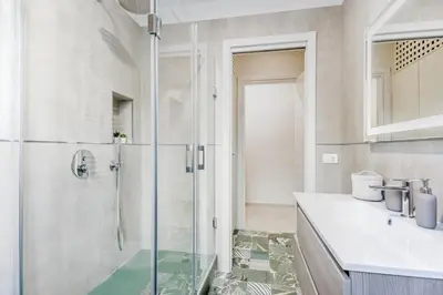 a bathroom with a glass shower and a sink at Biancaapartment in Rome