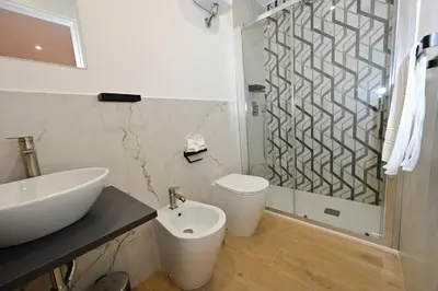 a bathroom with a sink and a toilet and a shower at Relais Trastevere Station in Rome