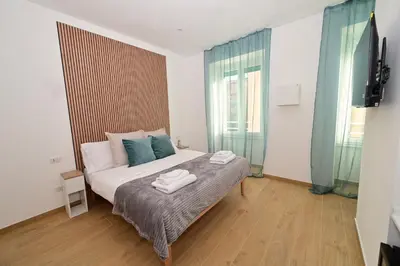a bedroom with a bed with two towels on it at Relais Trastevere Station in Rome