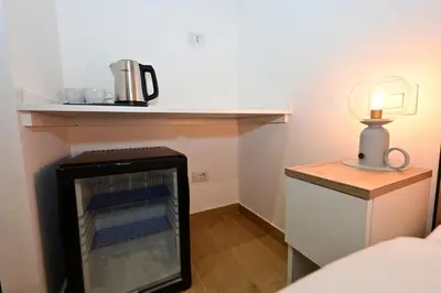 a small room with a refrigerator and a lamp at Relais Trastevere Station in Rome