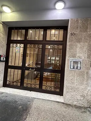 a building with a large door with glass windows at Casa Roma Metro B Tiburtina in Rome