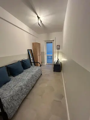 a bedroom with a bed and a view of the ocean at Casa Roma Metro B Tiburtina in Rome
