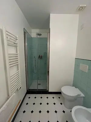 a bathroom with a shower and a toilet and a sink at Casa Roma Metro B Tiburtina in Rome