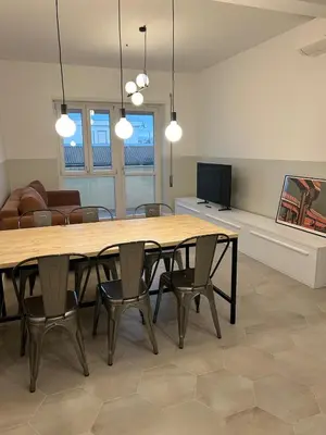 a dining room with a large wooden table and chairs at Casa Roma Metro B Tiburtina in Rome