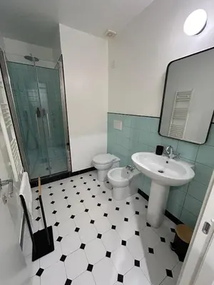 a bathroom with a toilet and a sink at Casa Roma Metro B Tiburtina in Rome