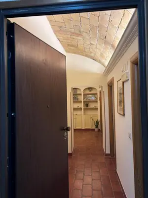 a hallway with a wooden door and a ceiling at Sophia s Home in Rome