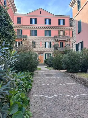 a stone path in front of a large building at Sophia s Home in Rome