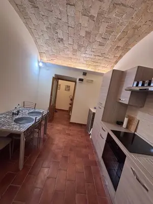 a kitchen with a table and a dining room at Sophia s Home in Rome