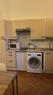 a kitchen with a washing machine and a microwave at loft 06 - new opening in Rome
