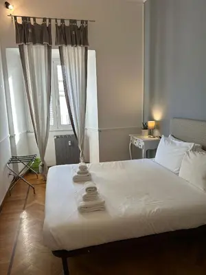 a bedroom with a large white bed with towels on it at loft 06 - new opening in Rome
