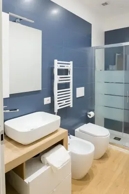 a bathroom with a white sink and a toilet at RoomApartment Roma in Rome