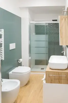 a bathroom with a toilet and a glass shower at RoomApartment Roma in Rome