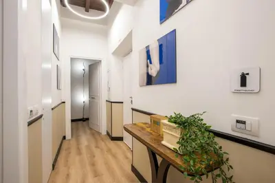a hallway with white walls and a wooden table at Pantheon Suites Rome 1 in Rome