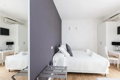 a bedroom with two beds and a mirror at Casa 901 - The Italian Stay Collection in Rome