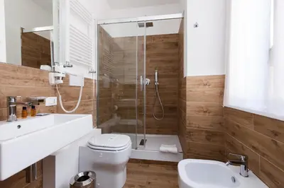 a bathroom with a shower and a toilet and a sink at Casa 901 - The Italian Stay Collection in Rome