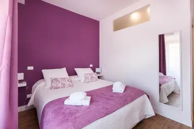 a bedroom with two beds with purple walls at Casa 901 - The Italian Stay Collection in Rome