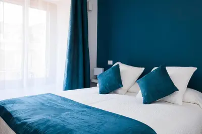 a blue bedroom with a bed with two blue pillows at Casa 901 - The Italian Stay Collection in Rome