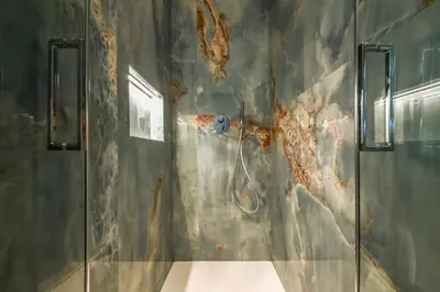 a bathroom with a shower with aopus on the wall at AP Royal suite guesthouse in Rome