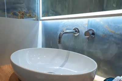 a sink in a bathroom with a faucet at AP Royal suite guesthouse in Rome