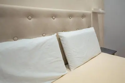 two pillows sitting on top of a bed at AP Royal suite guesthouse in Rome