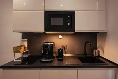 a kitchen with a microwave and a coffee maker on a counter at AP Royal suite guesthouse in Rome