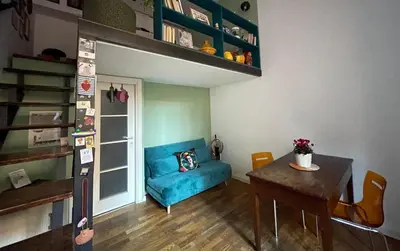 a living room with a blue couch and a table at il giardino di frida in Rome