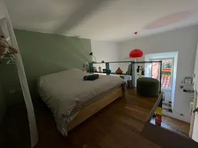 a bedroom with a bed and a green wall at il giardino di frida in Rome