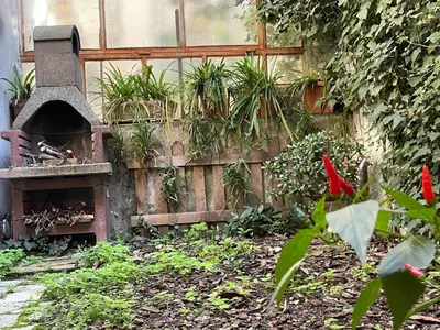 a garden with a bird house and a fence at il giardino di frida in Rome