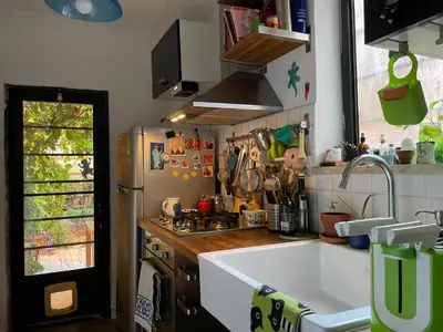 a kitchen with a sink and a refrigerator at il giardino di frida in Rome