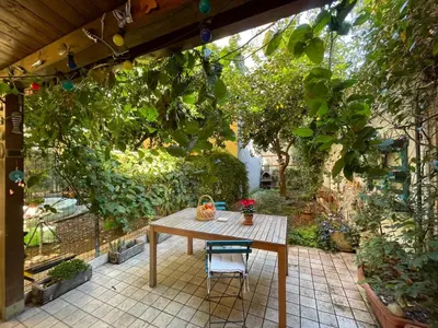 a table and a chair on a patio at il giardino di frida in Rome