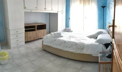 a bedroom with a large bed and a large window at B&B trastevere 2 in Rome